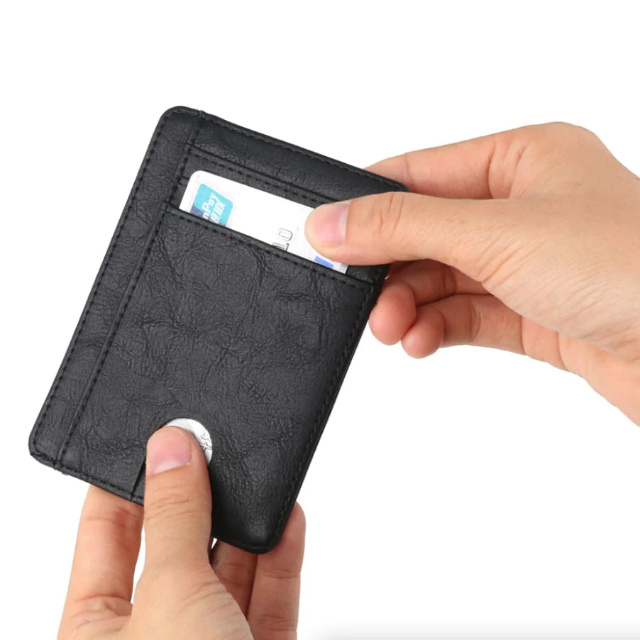 Vivid Living Mens Leather Slim Wallet Credit Card Holder in black shown held in hand with a card being inserted into the front slot. Ideal for minimalist everyday carry.